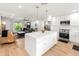 Bright, modern kitchen with white cabinetry, stainless steel appliances, and a center island at 7802 E Hubbell St, Scottsdale, AZ 85257