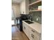 Modern laundry room with shaker cabinets, quartz countertop, a sink, and modern shelving at 7802 E Hubbell St, Scottsdale, AZ 85257