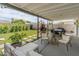 Covered patio area with modern outdoor seating, dining table, and artificial grass at 7802 E Hubbell St, Scottsdale, AZ 85257