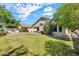 Expansive backyard featuring a lush lawn, mature trees, and a covered patio perfect for outdoor entertaining at 8009 W Salter Dr, Peoria, AZ 85382