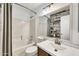 Bathroom featuring tub, shower, decorative mirror, and single-sink vanity at 8009 W Salter Dr, Peoria, AZ 85382