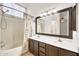 Well-lit bathroom featuring a double sink vanity, tile floors, and a shower-tub combination at 8009 W Salter Dr, Peoria, AZ 85382