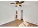 Bedroom with laminate flooring, chair rail, ceiling fan, and open closet at 8009 W Salter Dr, Peoria, AZ 85382