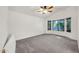 Bright bedroom with neutral carpet, large window, and ample natural light at 8009 W Salter Dr, Peoria, AZ 85382