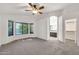 Spacious carpeted bedroom features a ceiling fan, bay window, bathroom, and walk-in closet at 8009 W Salter Dr, Peoria, AZ 85382