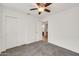 Bedroom with closet, chair rail, ceiling fan, and view of attached bathroom at 8009 W Salter Dr, Peoria, AZ 85382