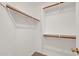 Walk in closet featuring carpeted floors, metal racks, and wood beams at 8009 W Salter Dr, Peoria, AZ 85382