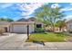 Charming single-story home featuring a well-manicured lawn, mature tree, and a two-car garage at 8009 W Salter Dr, Peoria, AZ 85382