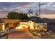Outdoor patio area with fire pit, built in seating, and landscape lighting at 8132 W Hatfield Rd, Peoria, AZ 85383