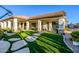 Expansive backyard featuring artificial grass, stone pathways, and a covered patio for outdoor enjoyment at 8132 W Hatfield Rd, Peoria, AZ 85383