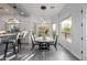 Bright dining area features a modern light fixture and large windows that bring the outside in at 8132 W Hatfield Rd, Peoria, AZ 85383