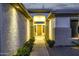 Inviting front entrance with stone columns and a wooden door nestled among lush greenery at 8132 W Hatfield Rd, Peoria, AZ 85383