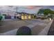 Charming single-story home with a three-car garage and a beautifully landscaped front yard at dusk at 8132 W Hatfield Rd, Peoria, AZ 85383