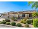 Well-maintained front exterior with desert landscaping, desert foliage, and a three-car garage at 8132 W Hatfield Rd, Peoria, AZ 85383