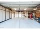 Well-organized garage featuring epoxy floors and built in cabinets for storage at 8132 W Hatfield Rd, Peoria, AZ 85383