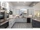 Modern white kitchen featuring stainless steel appliances, sleek countertops, and ample cabinet space at 8132 W Hatfield Rd, Peoria, AZ 85383