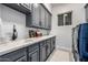 Well-equipped laundry room with ample counter space, storage cabinets, and modern washer/dryer at 8132 W Hatfield Rd, Peoria, AZ 85383