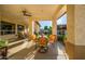 Covered patio with an outdoor dining area with seating and views of the yard at 8132 W Hatfield Rd, Peoria, AZ 85383