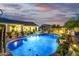 Inviting pool area with a stone edge, lush landscaping, and outdoor dining space at 8132 W Hatfield Rd, Peoria, AZ 85383