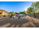 Large backyard swimming pool with lush landscaping and an outdoor dining area at 8132 W Hatfield Rd, Peoria, AZ 85383