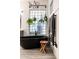 Modern bathroom with black standalone tub, towel warmer, and stool at 8132 W Hatfield Rd, Peoria, AZ 85383