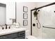 Well-lit bathroom featuring a glass shower with matte black hardware and marble patterned tile at 8132 W Hatfield Rd, Peoria, AZ 85383