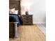 Warm bedroom features a dark wooden bed frame with a jute rug and matching nightstand at 8132 W Hatfield Rd, Peoria, AZ 85383