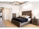 Bright bedroom shows a dark wooden bed frame with dual nightstands and soft overhead lighting at 8132 W Hatfield Rd, Peoria, AZ 85383