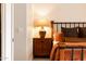 Nightstand lamp illuminates a charming bedroom showcasing a wooden nightstand with drawers and a rustic bed at 8132 W Hatfield Rd, Peoria, AZ 85383