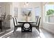 Bright dining area featuring stylish table, chairs, and views from the windows at 8132 W Hatfield Rd, Peoria, AZ 85383