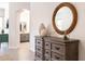 Inviting foyer displays a wood dresser with a decorative mirror and vase accents at 8132 W Hatfield Rd, Peoria, AZ 85383