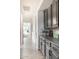 Hallway featuring hardwood floors and grey cabinets with decor accents at 8132 W Hatfield Rd, Peoria, AZ 85383