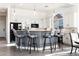 Bright, modern kitchen with white cabinetry, breakfast bar, and seating at 8132 W Hatfield Rd, Peoria, AZ 85383