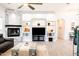 Spacious living room with stone fireplace, built-in shelving, and open design concept at 8132 W Hatfield Rd, Peoria, AZ 85383