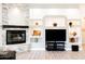 Bright living room featuring a fireplace and built-in shelving for decor at 8132 W Hatfield Rd, Peoria, AZ 85383