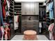 Spacious walk-in closet with custom shelving, drawers, and a pink ottoman at 8132 W Hatfield Rd, Peoria, AZ 85383