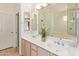 Bathroom featuring double sinks, a large mirror, and separate tub and shower at 8270 N Hayden Rd # 2041, Scottsdale, AZ 85258