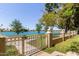 Lake view featuring a wrought iron fence and lush landscaping in a tranquil community setting at 8270 N Hayden Rd # 2041, Scottsdale, AZ 85258