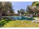 Scenic pond surrounded by mature trees and rock features, creating a peaceful atmosphere at 8270 N Hayden Rd # 2041, Scottsdale, AZ 85258