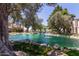 Serene pond featuring water fountains, lush landscaping, and rocks for tranquil community living at 8270 N Hayden Rd # 2041, Scottsdale, AZ 85258