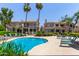 Community pool featuring chaise lounges and tall palm trees, providing a relaxing outdoor oasis at 8270 N Hayden Rd # 2041, Scottsdale, AZ 85258