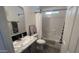 Well-lit bathroom featuring a vanity with marbled countertop and shower over tub at 9333 E University Dr # 57, Mesa, AZ 85207