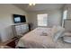 Bright bedroom with a large window, ceiling fan and built-in dresser at 9333 E University Dr # 57, Mesa, AZ 85207