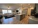 Open-concept living space flows from a large kitchen island to a cozy living area filled with natural light at 9333 E University Dr # 57, Mesa, AZ 85207