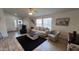 Inviting living room area featuring cozy seating, wood-look flooring, and ample natural light at 9333 E University Dr # 57, Mesa, AZ 85207
