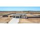 Aerial view of single-Gathering home with three-car garage and a walled-in yard at 9429 W Sandstone Mountain Dr, Casa Grande, AZ 85194