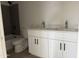 Modern bathroom with double sink vanity, sleek fixtures, and a shower-tub combo at 9429 W Sandstone Mountain Dr, Casa Grande, AZ 85194
