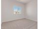 An empty bedroom offers a view of the home across the street from the window at 9429 W Sandstone Mountain Dr, Casa Grande, AZ 85194