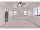 Large bedroom features a ceiling fan, plush carpeting, and large windows that offer plenty of natural light at 9429 W Sandstone Mountain Dr, Casa Grande, AZ 85194