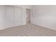 This bedroom features carpet, white walls, a closet, and a door leading to an adjoining room at 9429 W Sandstone Mountain Dr, Casa Grande, AZ 85194